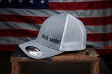 Side view of the Nasty Bagger Trucker Hat with an American Flag backdrop.